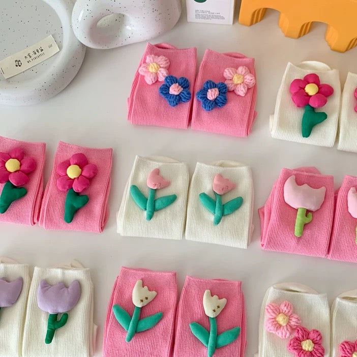Small pouches with floral designs on a white surface