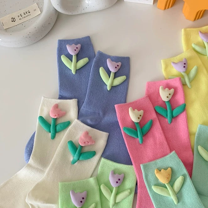Colorful socks with floral designs on a white surface