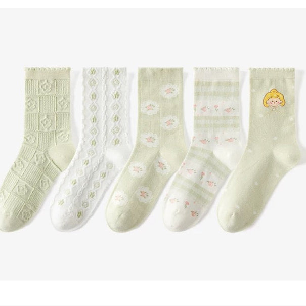 Set of five pairs of light green socks with different patterns on a white background