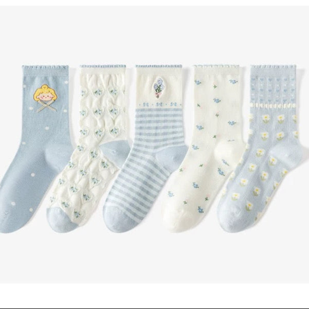 Set of five pairs of socks with different patterns on a white background