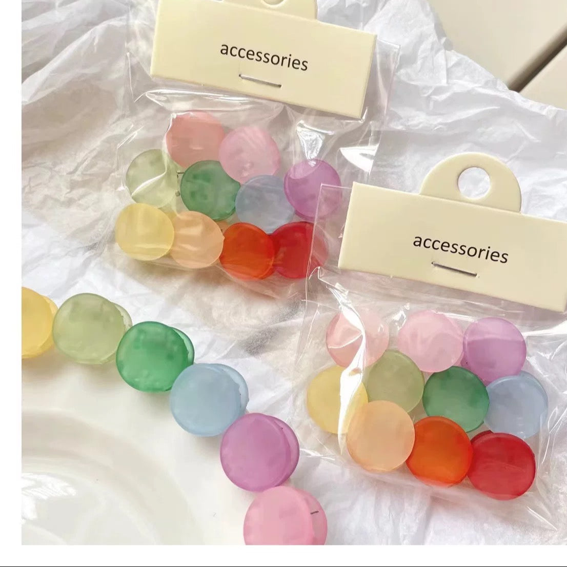 Colorful accessories in clear bags with 'accessories' labels on a white background