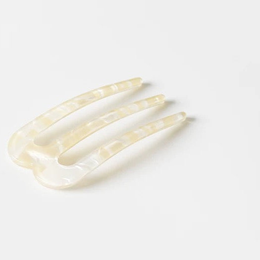 Hair comb with '' branding on a white background