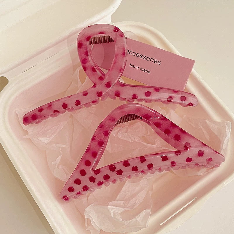 Pink polka dot hair clips in a clear plastic case with a pink card labeled 'Accessories hand made'.