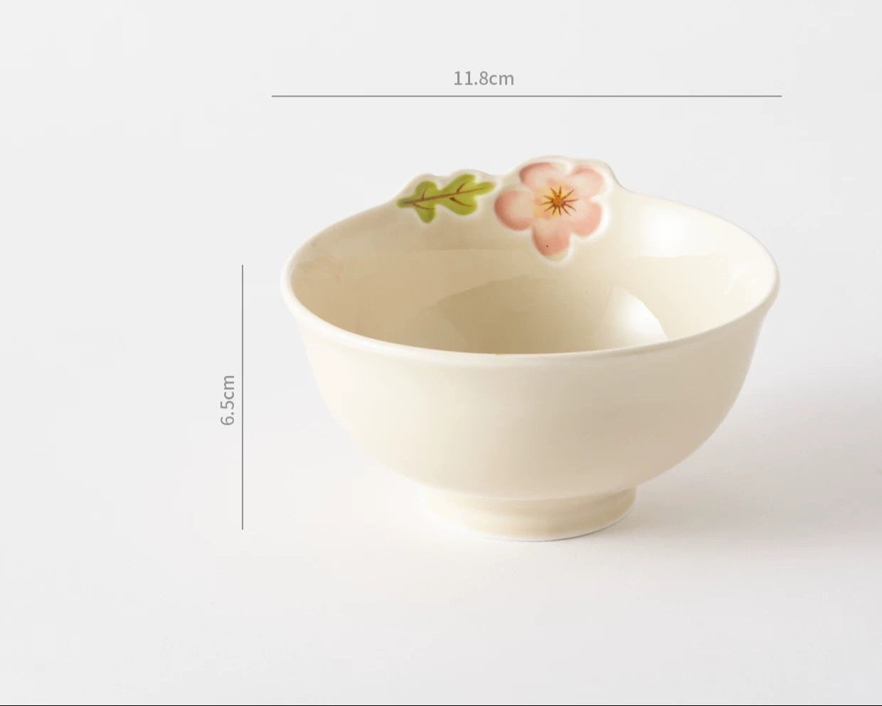 White ceramic bowl with floral design on a white background