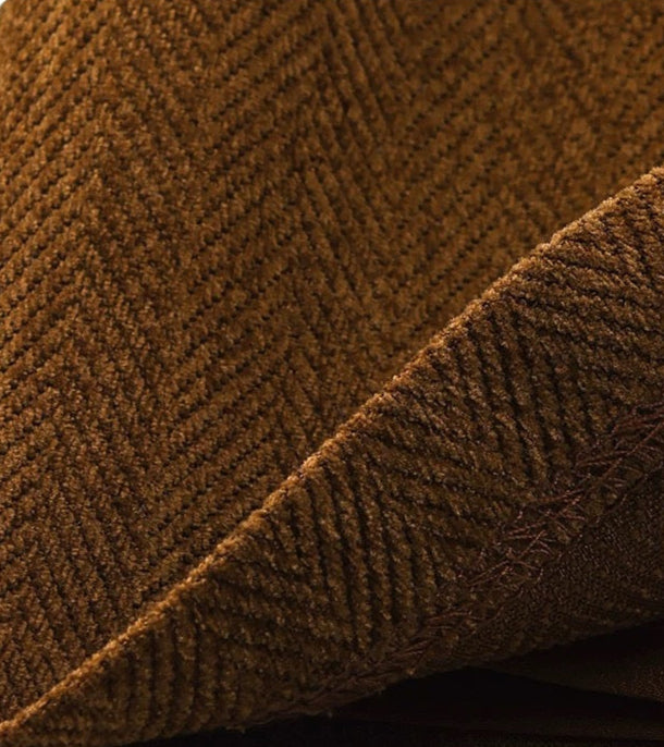 Brown textured fabric with a herringbone pattern on a white background