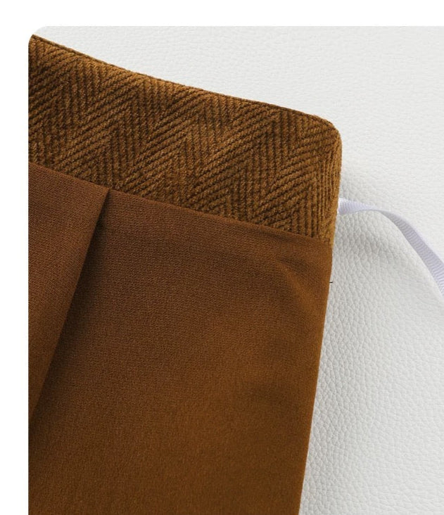 Brown fabric with herringbone pattern on a white background