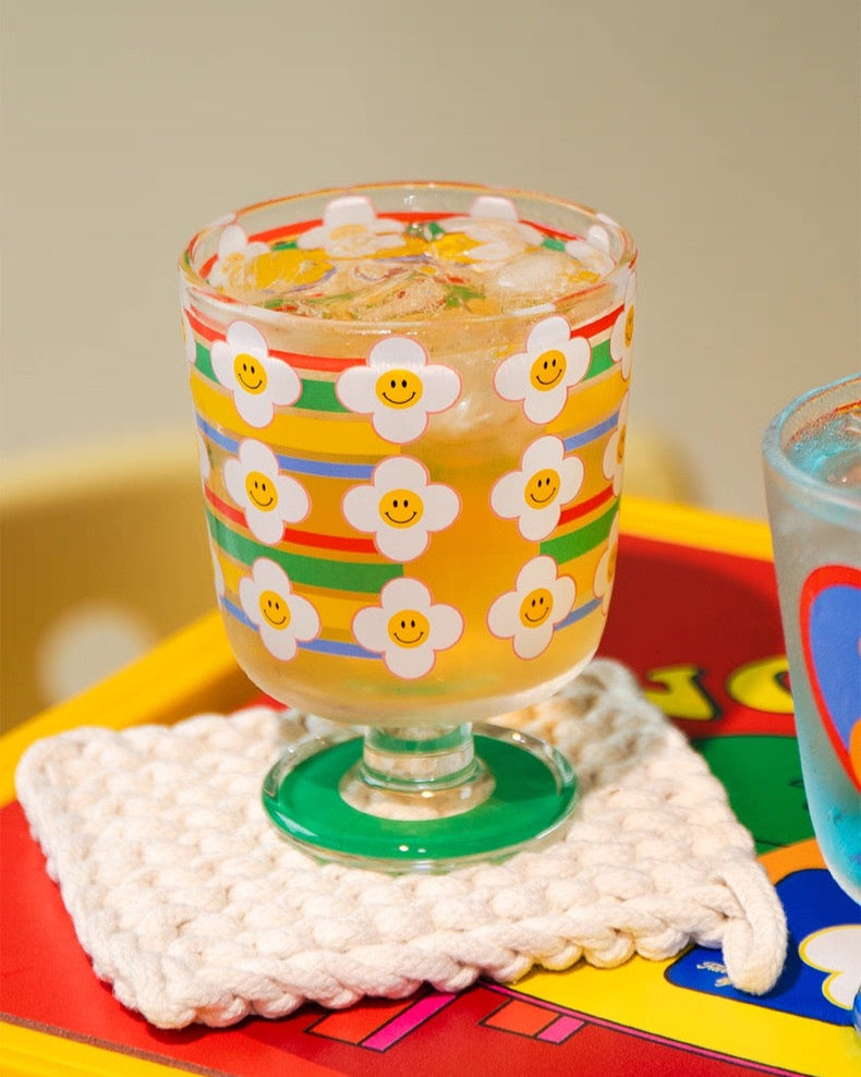 Colorful glass with floral design on a colorful surface