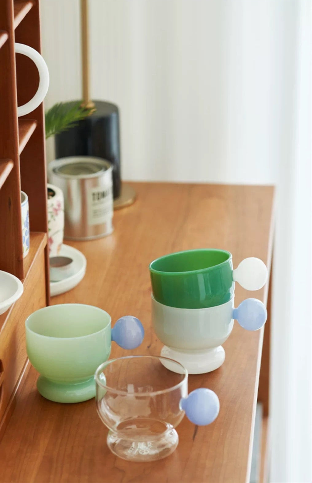 Colorful cups on a wooden surface with a blurred background