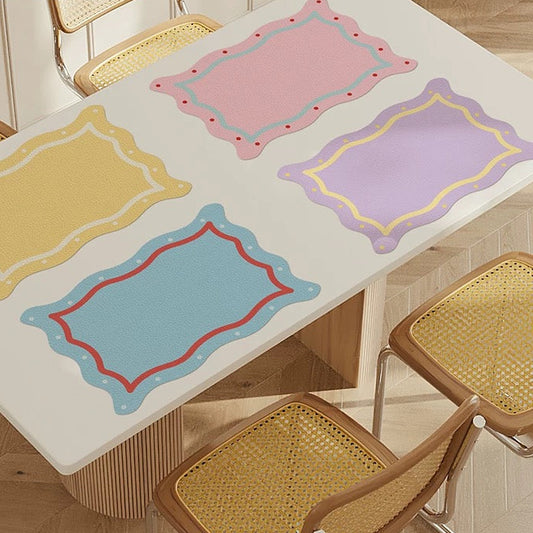 Dining table with colorful placemats and wicker chairs in a room.