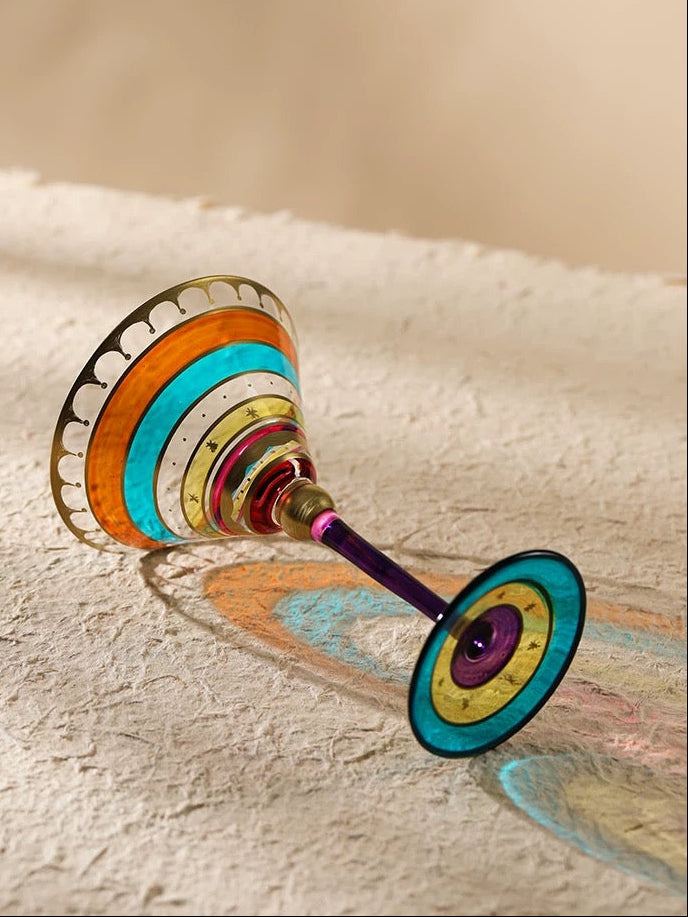 Colorful glass with a unique design on a textured surface