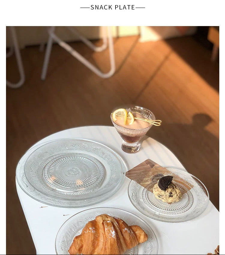 Snack plate with pastries and a glass on a wooden table.