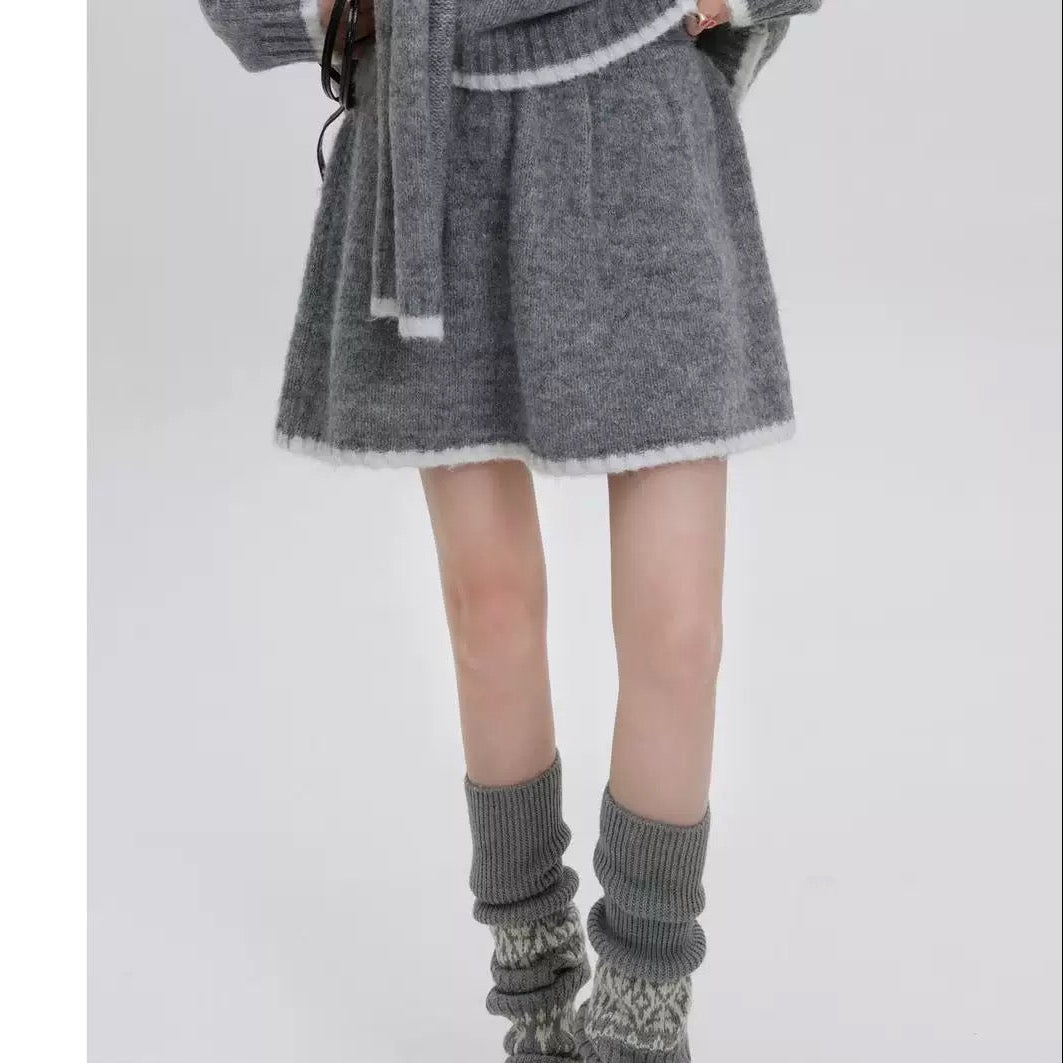 Person wearing a gray knit skirt and matching knee-high socks with a white background, featuring 'Yingzi Collection' branding.