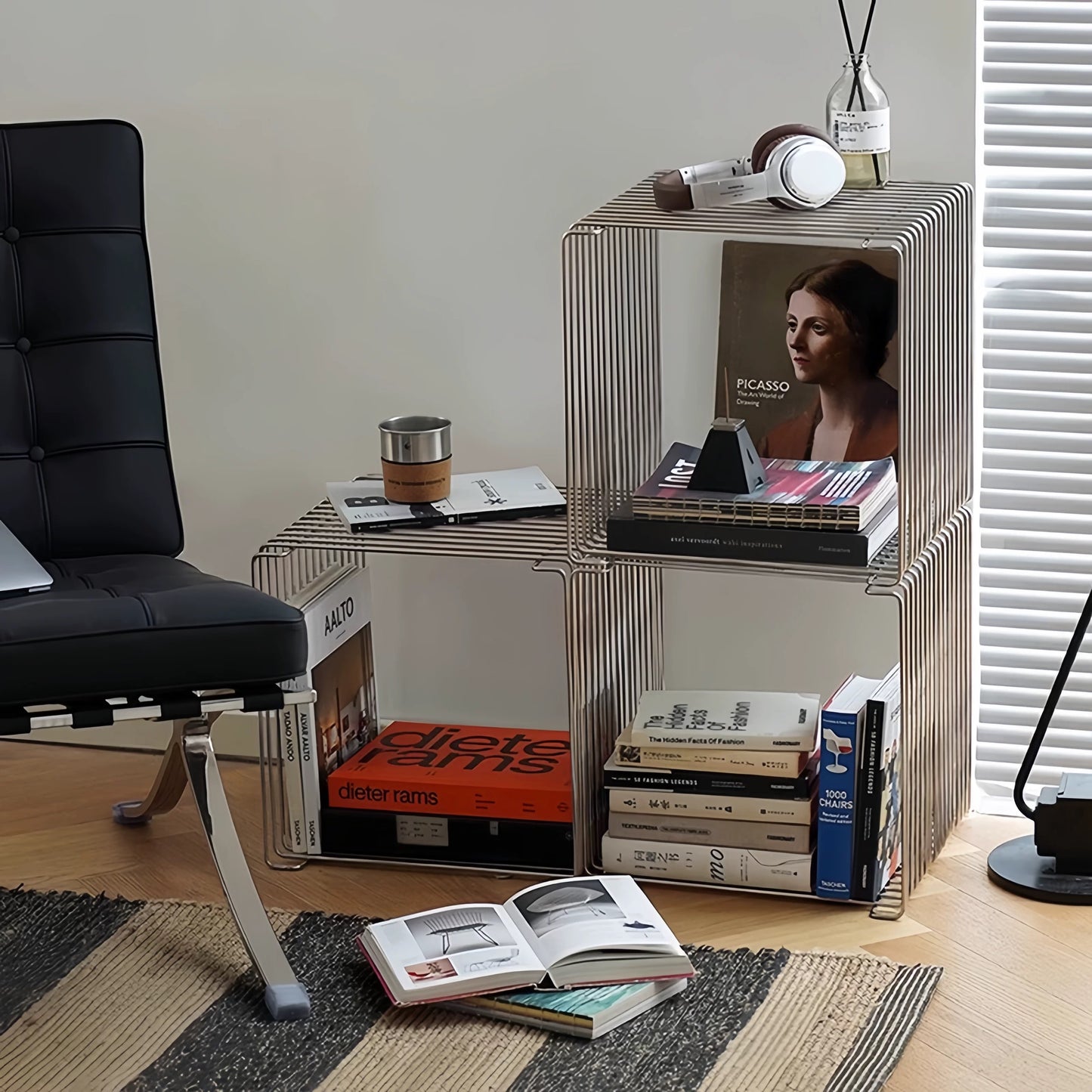 Modern side table with books and a chair in a room setting