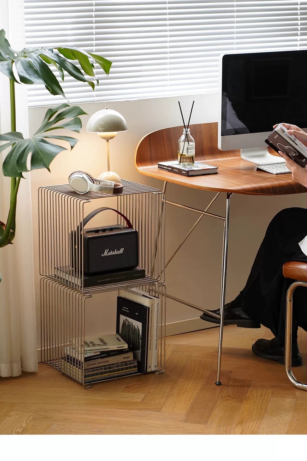 Modern home office with desk, computer, and Marshall speaker.