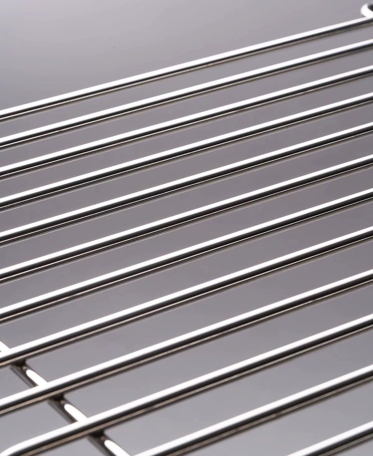 Close-up of a metal cooling rack on a gray background