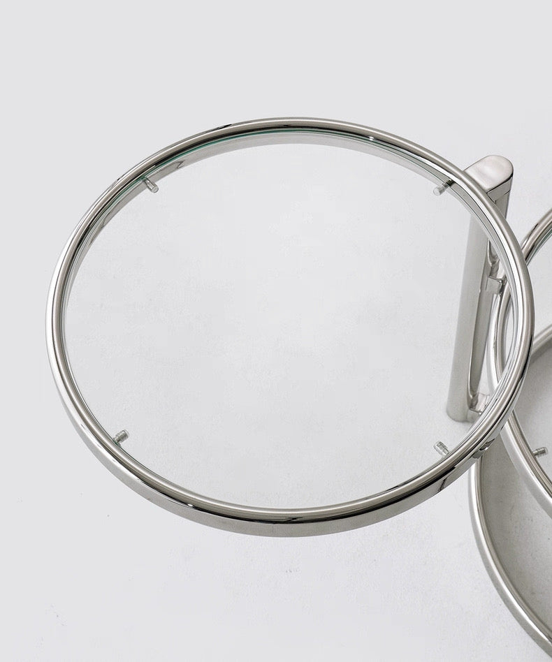 Close-up of a silver ring with a clear gemstone on a light gray background