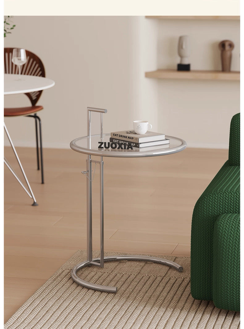 Glass side table with metal base in a living room setting
