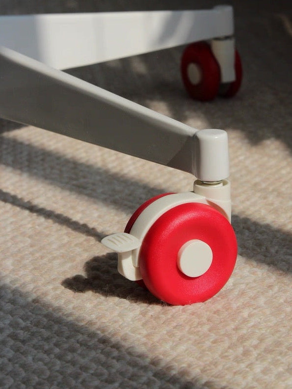 Close-up of a red wheel on a piece of furniture with 'today home' branding.