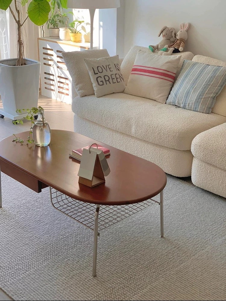 Living room with a beige sofa, wooden coffee table, and decorative pillows.