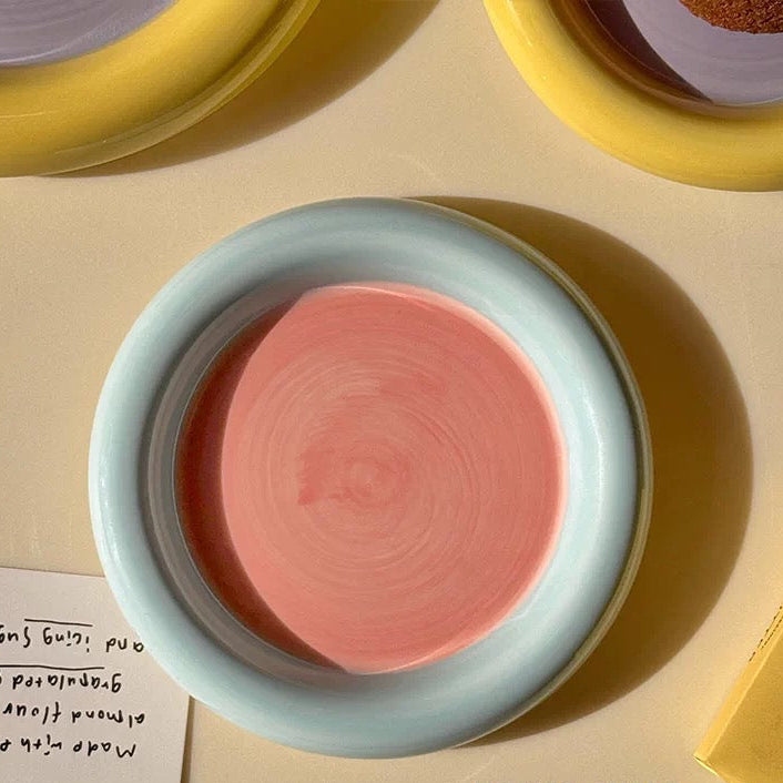 Pink ceramic dish on a beige surface with text overlay