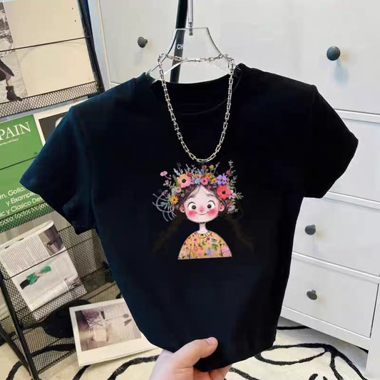 Black t-shirt with a colorful graphic of a girl with flowers in her hair, held by a hand.