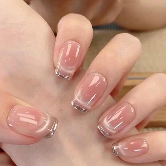 Close-up of a hand with pink nail polish on a neutral background