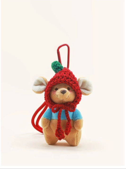 Small teddy bear keychain with a red hood on a white background, featuring the brand ''.