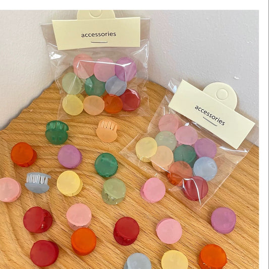Colorful round accessories on a wooden surface with clear bags labeled 'accessories'.
