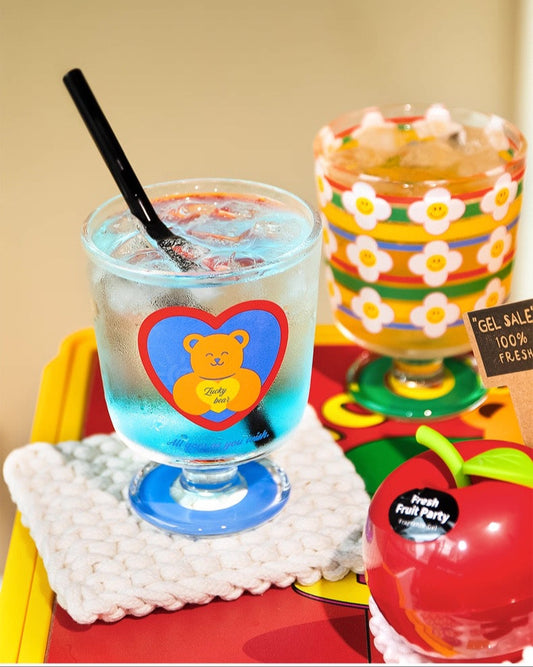 Two colorful drinks with decorative elements on a table